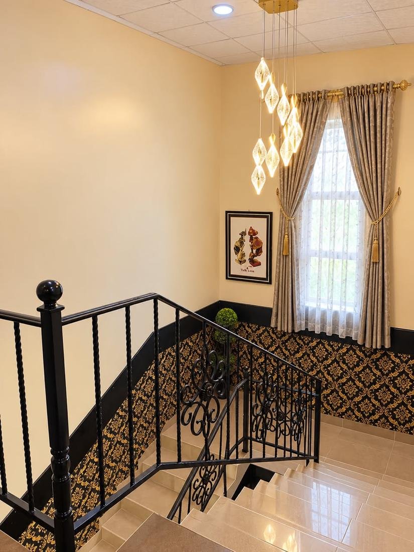 Staircase with chandelier and patterned wall panels